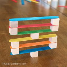 a toy made out of pops sticks sitting on top of a wooden table