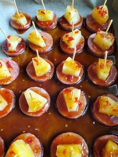 several appetizers are arranged on a tray with toothpicks