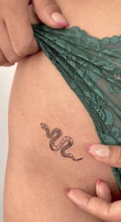 a woman's stomach with a snake tattoo on her belly and the word love written in cursive writing