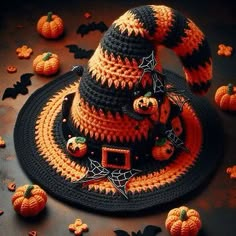 a crocheted halloween hat with pumpkins around it