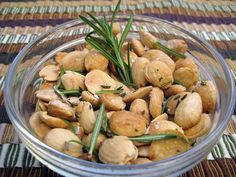 a glass bowl filled with nuts on top of a table