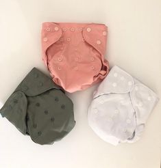 three cloth diapers sitting next to each other