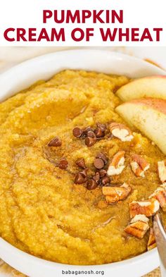 pumpkin cream of wheat in a white bowl with pecans and apples on the side