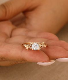 a woman's hand holding an engagement ring