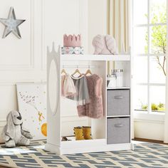 a child's room with white furniture and toys on the floor, including a teddy bear