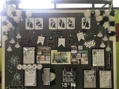 a bulletin board with pictures and decorations on the blackboard, decorated with white pom poms