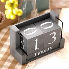 a wooden block calendar sitting on top of a table