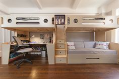 a loft bed is built into the side of a room with stairs and desks