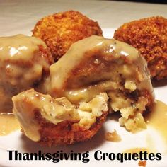 three meatballs covered in gravy on a white plate with the words thanksgiving croquettes