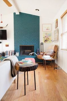 a living room filled with furniture and a fire place next to a wall mounted tv