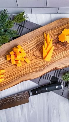 a cutting board with cheese on it next to a knife