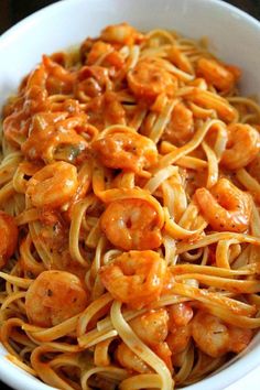 pasta with shrimp and tomato sauce in a white bowl