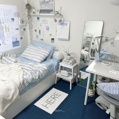 a bedroom with blue carpet and white walls