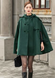 "This Wool cape is a gorgeous clothing with hood, design with hip pockets. This winter cape is made from soft wool fabric,the green wool cape is completely lined in polyester with fabulous flap detailing on the front, shoulders, pockets and back. This is a women's hooded cape you will wear forever. The stylish design will gives a retro feeling and keep you warm in winter days. Put it on, you will be the focus of everyone's attention. Detail * The coat is the perfect gift for everyone. This beaut Casual Cape For Cold Weather, Casual Cape Outerwear With Pockets, Hooded Solid Pea Coat With Pockets, One Size Winter Cape, Hooded Pea Coat With Pockets For Outdoor, Solid Hooded Cape For Fall, Oversized Green Cape For Fall, Hooded Poncho With Pockets For Fall, Casual Solid Color Cape Outerwear