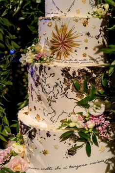 a three tiered wedding cake with flowers on it