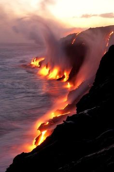 lava flowing out of the ocean into the air