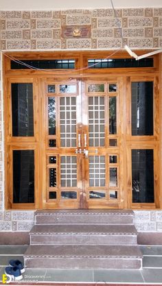 a pair of shoes are sitting on the steps in front of a building with wooden doors and windows