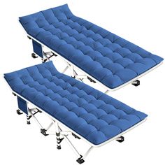 two blue beds sitting next to each other on top of metal casteors and wheels