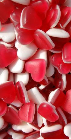 red and white candy hearts are piled together