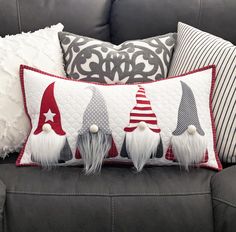 the pillows are decorated with gnome hats and red white and blue colors on them, along with other decorative items