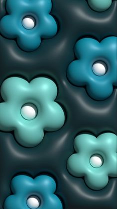 some blue and green flowers are floating in the water with white balls around them on a black background