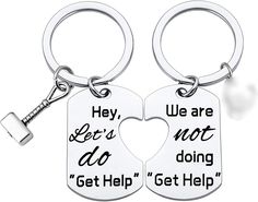 two keychains with the words hey, we are not doing get help