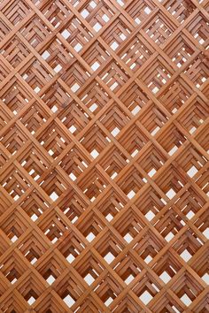 a close up view of a wooden structure with many squares on it's sides