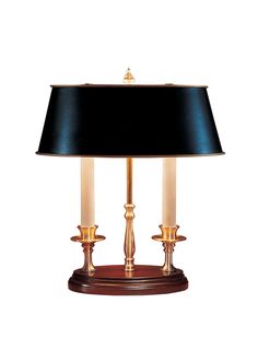 a lamp that is sitting on top of a wooden stand with a black lampshade