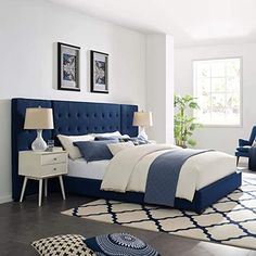 a bedroom with white walls and blue bedding