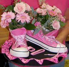 a pair of pink shoes with flowers in them