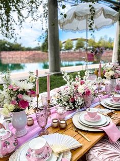 the table is set with pink and white dishes