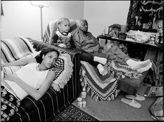 three people sitting on couches in a living room