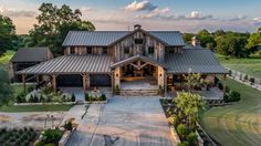 this is an aerial view of a large house in the country side with lots of trees and grass