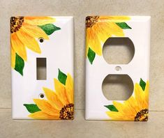 two sunflowers painted on white electrical outlet covers