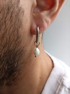 Mens single pearl earring,Small huggie hoops real pearl square hoop earrings,Mens pearl hoops,Mens mono teardrop dangle earring ! Earrings are sold individually (the price is for 1 piece but you can buy a pair for both ears)! Hypoallergenic stainless steel earring (does not rust, does not darken) + real baroque pearl = a great addition to your image and character. You are modern, energetic, keep up with the times, you are unique... this jewelry is for you! The pearl can be easily removed and worn as a hoop earring. Real baroque pearl, stainless steel. Total length earring - 3 cm ≈ 1.18 inch Height hoop - 1,5 cm ≈ 0.59 inch Width hoop - 1,2 cm ≈ 0.47 inch Weight of one earring - 2 g ≈ 0.07 oz. All natural gemstones may vary in hue and shape, so may appear slightly different from photographs Men’s Pearl Earrings, Men Wearing Earrings, Single Pearl Earrings, Mens Earring, Earrings Mens, Earrings Men, Square Hoop Earrings, Single Pearl, Teardrop Dangle Earrings