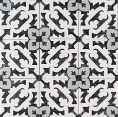 a black and white tile pattern with an ornate design in the center, on top of a