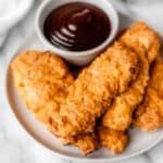 fried chicken on a plate with dipping sauce