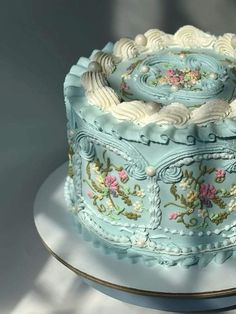 there is a blue cake with flowers on it