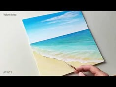 someone is painting an ocean scene with watercolors