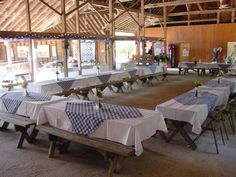 tables and benches are set up in an open room with large windows to the side