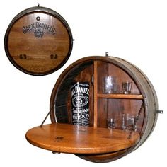 a wooden shelf with two wine glasses and a bottle on it next to a barrel