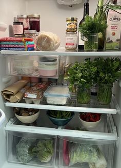 an open refrigerator filled with lots of different types of vegetables and food in it's doors