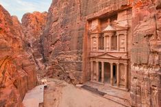 an ancient building carved into the side of a mountain