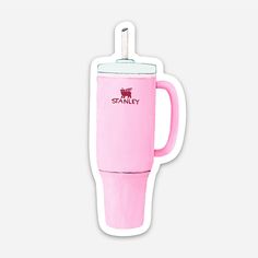 a pink coffee cup shaped sticker sitting on top of a white surface with the word stanley printed on it