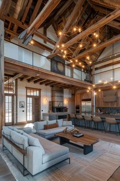 a living room with couches, tables and chairs inside of an open floor plan