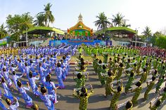 a large group of people in blue and green outfits