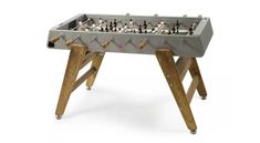 a foosball table with wooden legs is shown