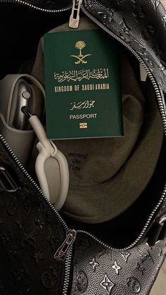 a bag with a passport and headphones in it