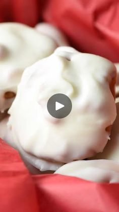 some white icing is on top of red paper and it looks like they are eating something