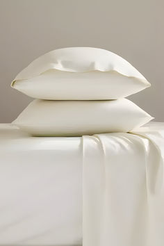 three white pillows stacked on top of each other